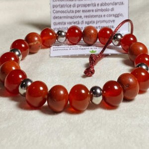 Bracciale Diaspro Rosso e Corniola - pietre naturali e acciaio - elastico Linea Gimo_Jewels Realizzato con pietre naturali di Corniola e Diaspro Rosso, il bracciale si adatta bene al polso grazie al suo elastico morbido ma resistente e anallergico. La corniola si forma nelle rocce vulcaniche a partire da magmi acidi contenenti ferro. Se si sottopone il minerale a un leggero riscaldamento, il suo colore diventa più intenso. Da sempre considerata portatrice di prosperità e abbondanza, è conosciuta per essere simbolo di determinazione, resistenza e coraggio, questa varietà di agata promuove stabilità e senso di appartenenza.